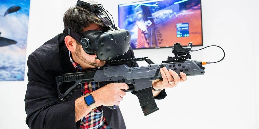 A person testing a VR game with a headset and gun controller