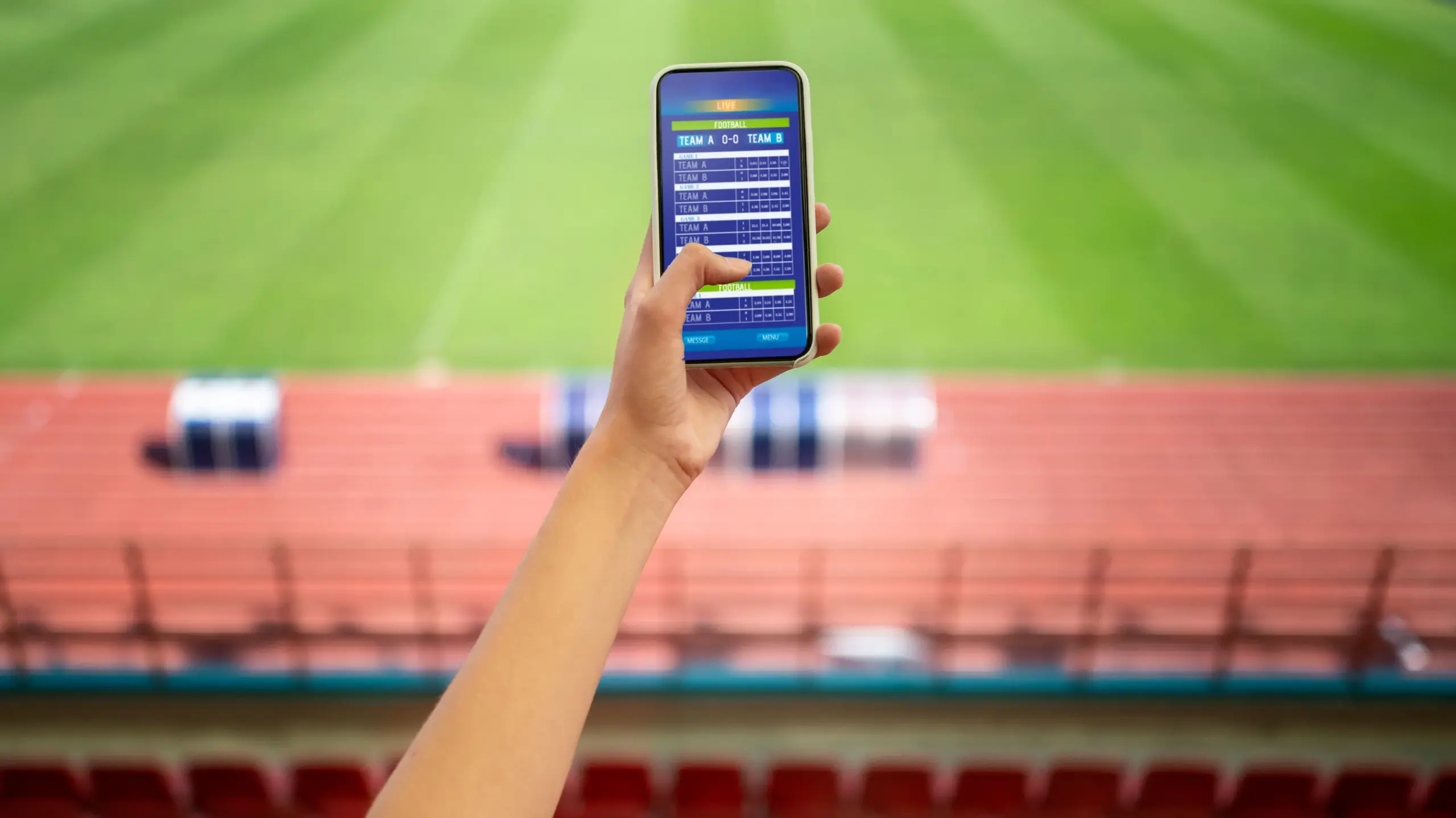 Fan using mobile sports prediction app during live match